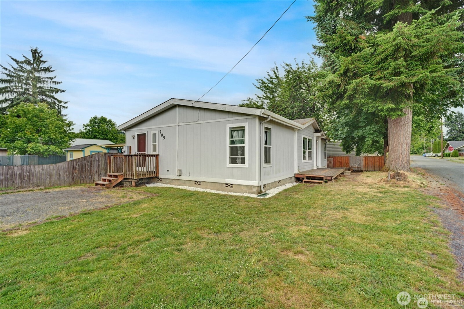 a view of a backyard with a garden and tree