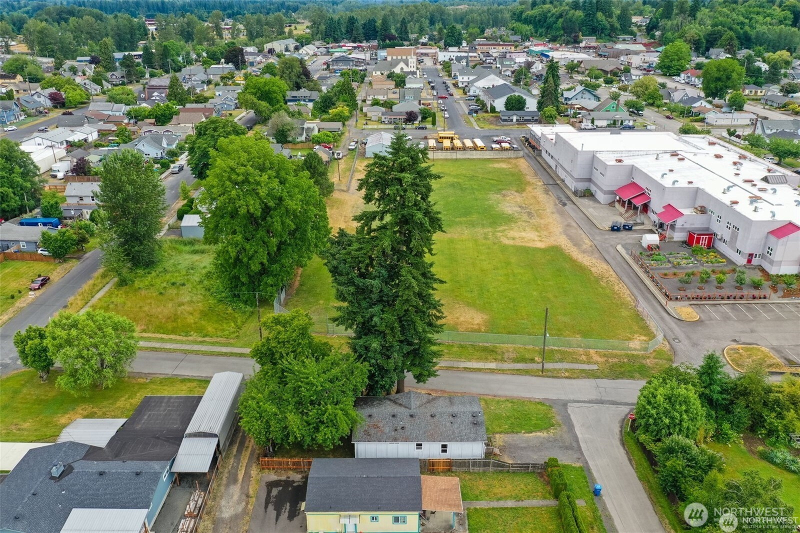 705 1st Avenue Southwest Castle Rock, WA 98611 - Photo 11 of 11 an aerial view of residential houses with outdoor space and swimming pool