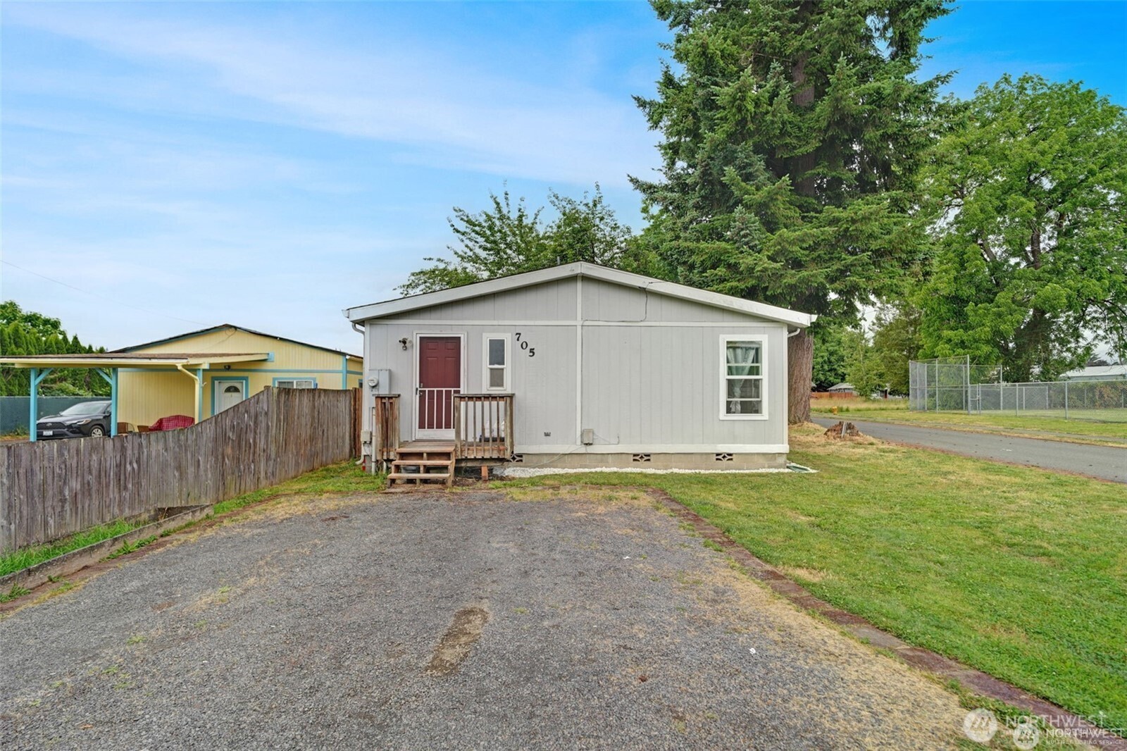 705 1st Avenue Southwest Castle Rock, WA 98611 - Photo 3 of 11 a view of a house with backyard and sitting area