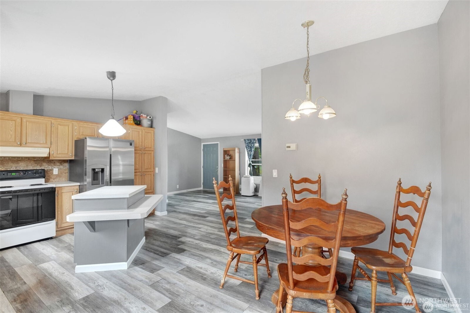 705 1st Avenue Southwest Castle Rock, WA 98611 - Photo 7 of 11 a view of a dining room with furniture a chandelier and wooden floor