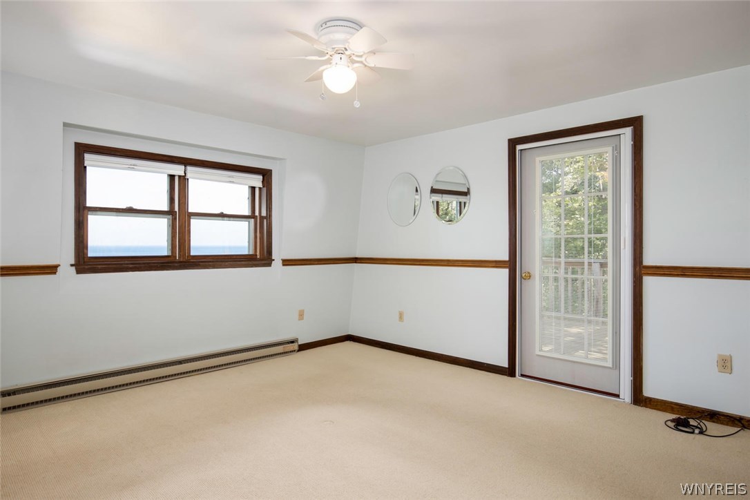 629 Lake Road Porter, NY 14174 - Photo 17 of 35 Master Bedroom with water view and access to an up