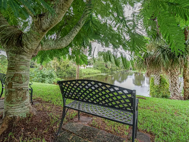 a wooden bench sitting in back yard of a house