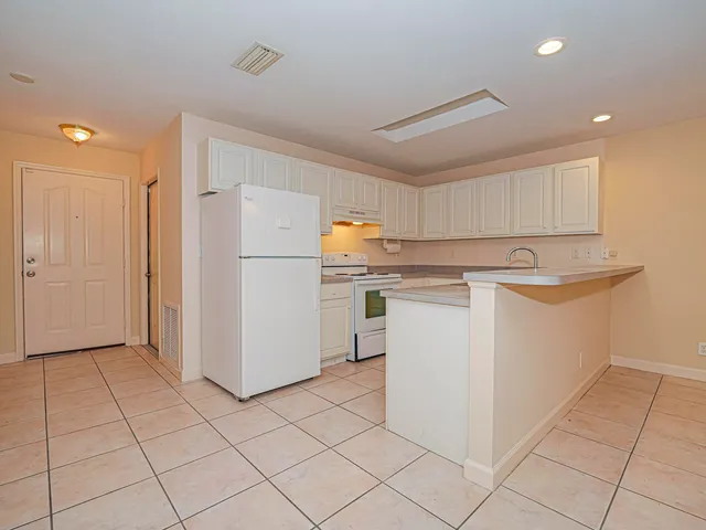 a utility room with cabinets washer and dryer