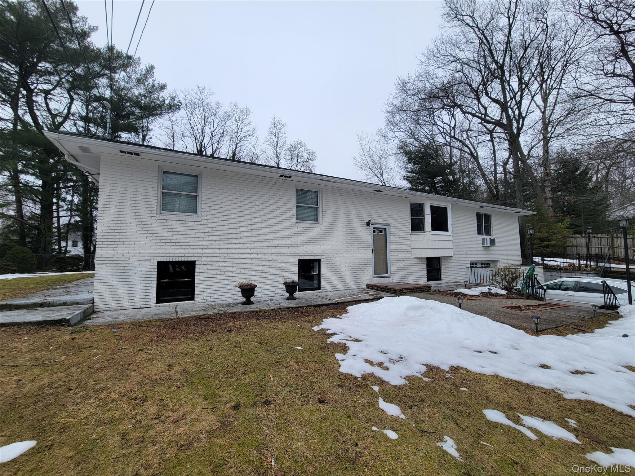 96 Hallock Landing Road Rocky Point, NY 11778 - Photo 1 of 13 a front view of house with yard and trees in the background