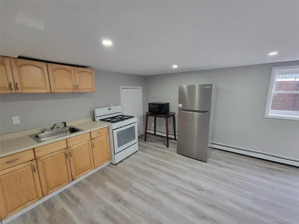 a kitchen with refrigerator cabinets and wooden floor