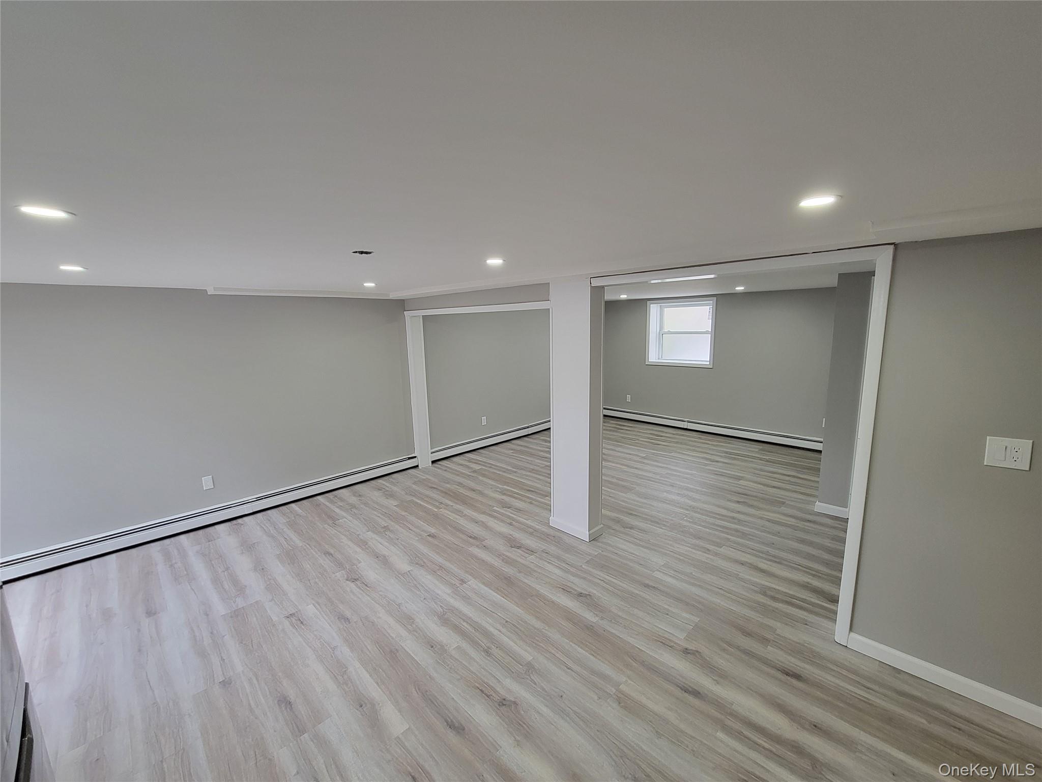 96 Hallock Landing Road Rocky Point, NY 11778 - Photo 2 of 13 a view of an empty room with wooden floor
