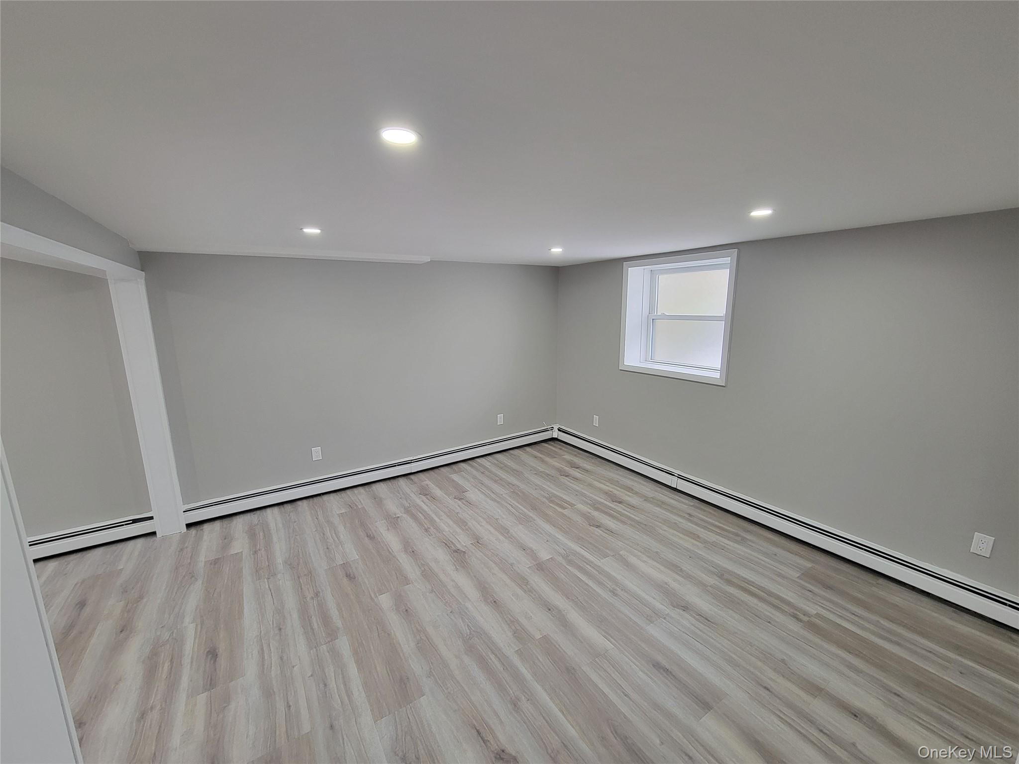 96 Hallock Landing Road Rocky Point, NY 11778 - Photo 3 of 13 a view of an empty room with wooden floor