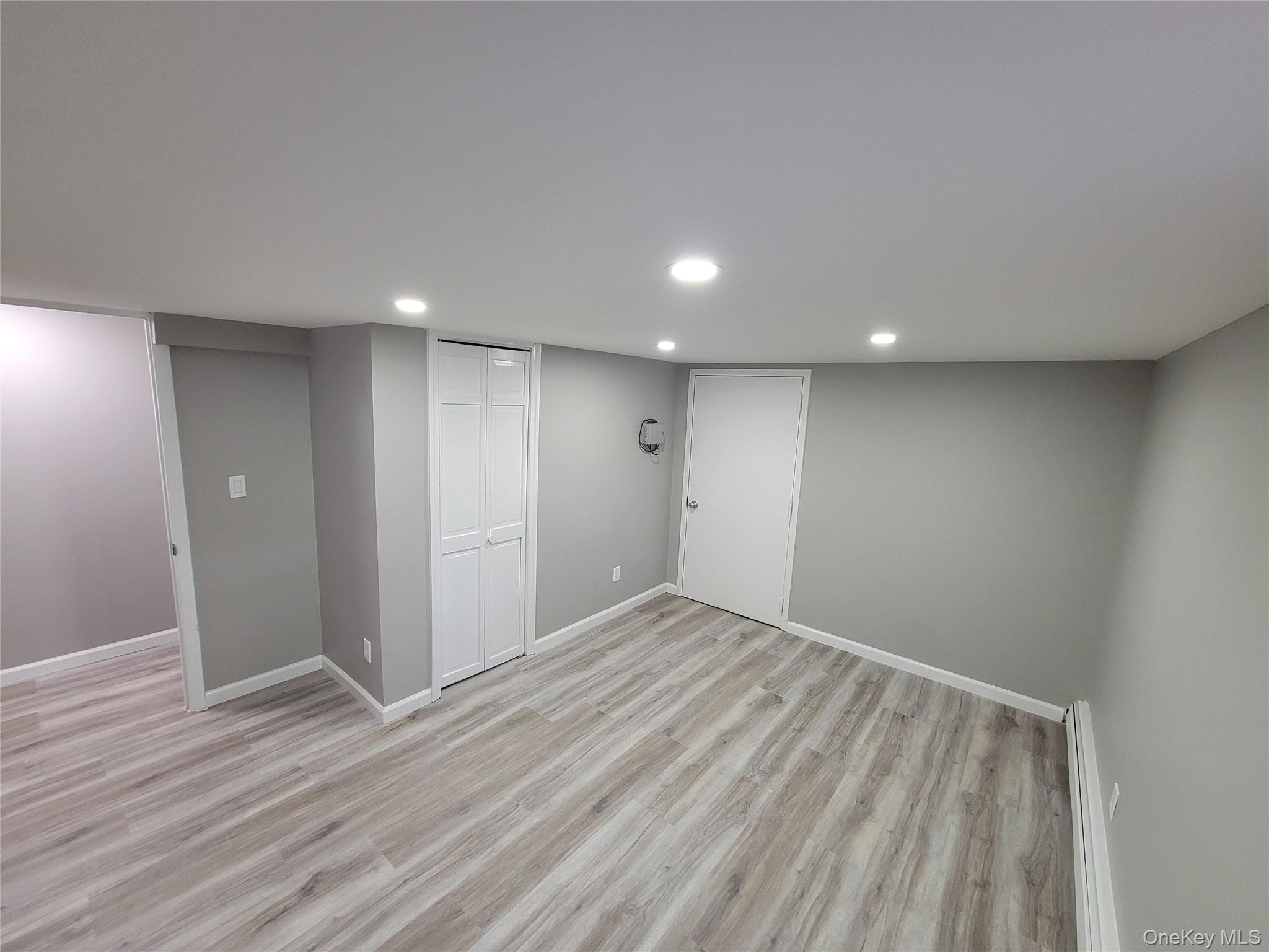 96 Hallock Landing Road Rocky Point, NY 11778 - Photo 6 of 13 a view of an empty room with wooden floor