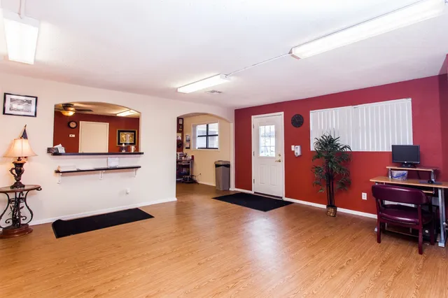 a living room with furniture and wooden floor