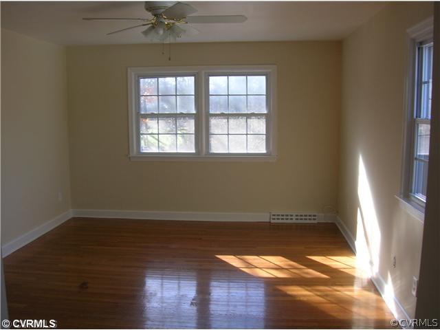 11451 Rolling Brook Road Chester, VA 23831 - Photo 6 of 11 an empty room with wooden floor and windows