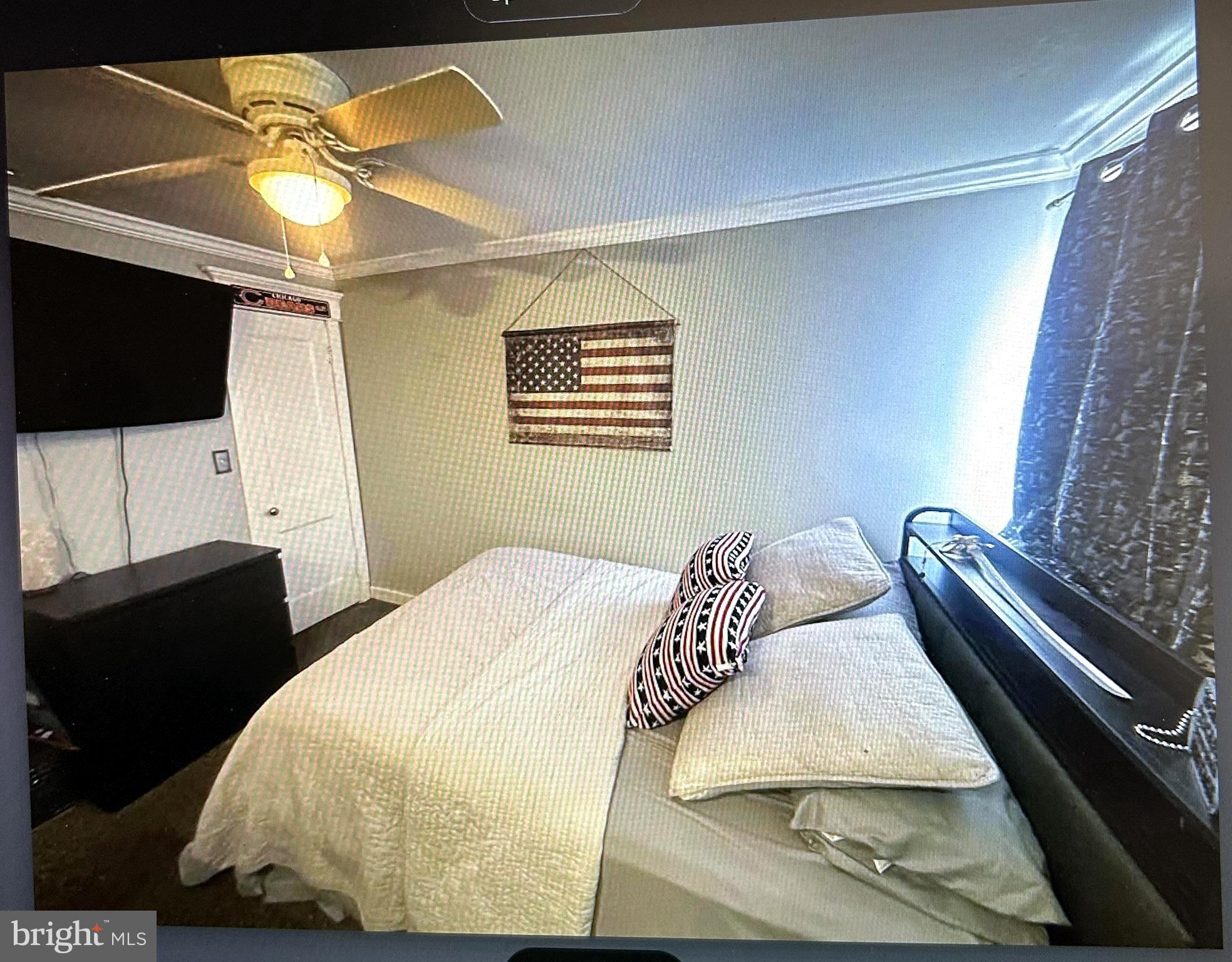 723 Newportville Road Croydon, PA 19021 - Photo 14 of 23 a bedroom with a bed and a flat tv screen on a dresser