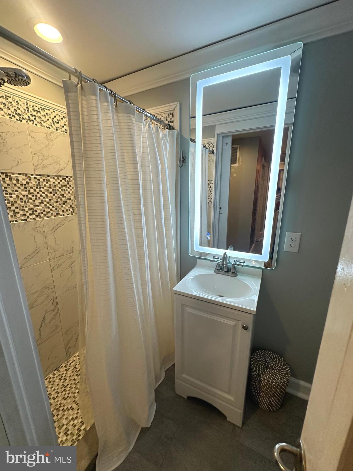 723 Newportville Road Croydon, PA 19021 - Photo 16 of 23 a bathroom with a sink a mirror and a shower