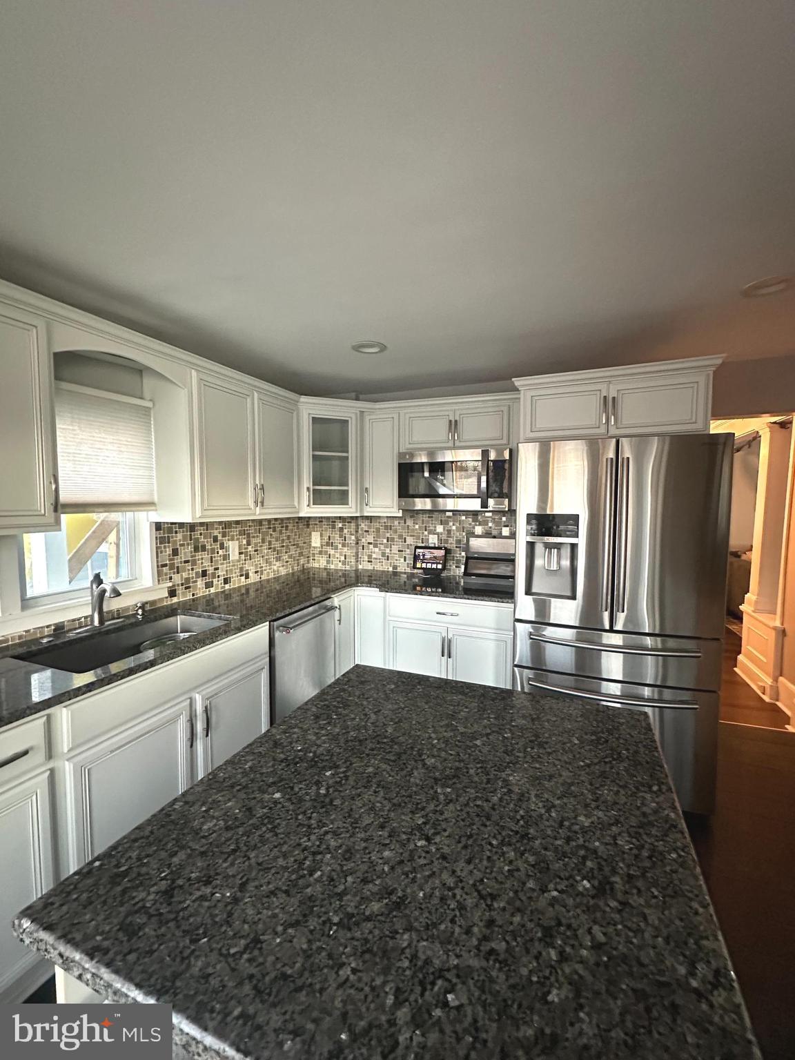 723 Newportville Road Croydon, PA 19021 - Photo 5 of 23 a kitchen with granite countertop a refrigerator and a stove top oven