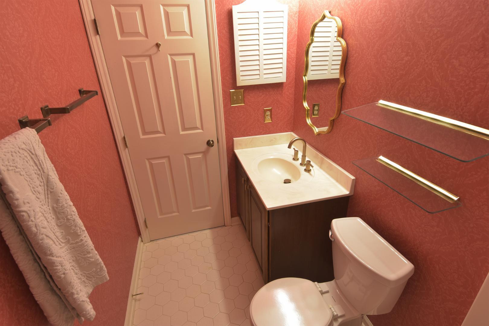 6403 Andsley Drive Raleigh, NC 27609 - Photo 14 of 18 a bathroom with a toilet sink and mirror