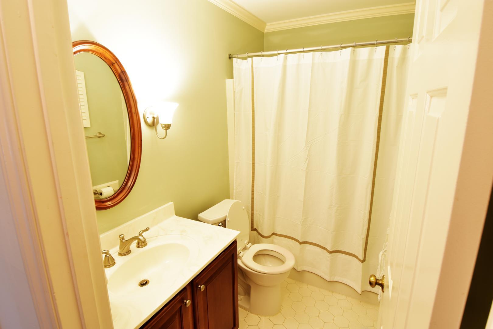 6403 Andsley Drive Raleigh, NC 27609 - Photo 16 of 18 a bathroom with a sink and a mirror