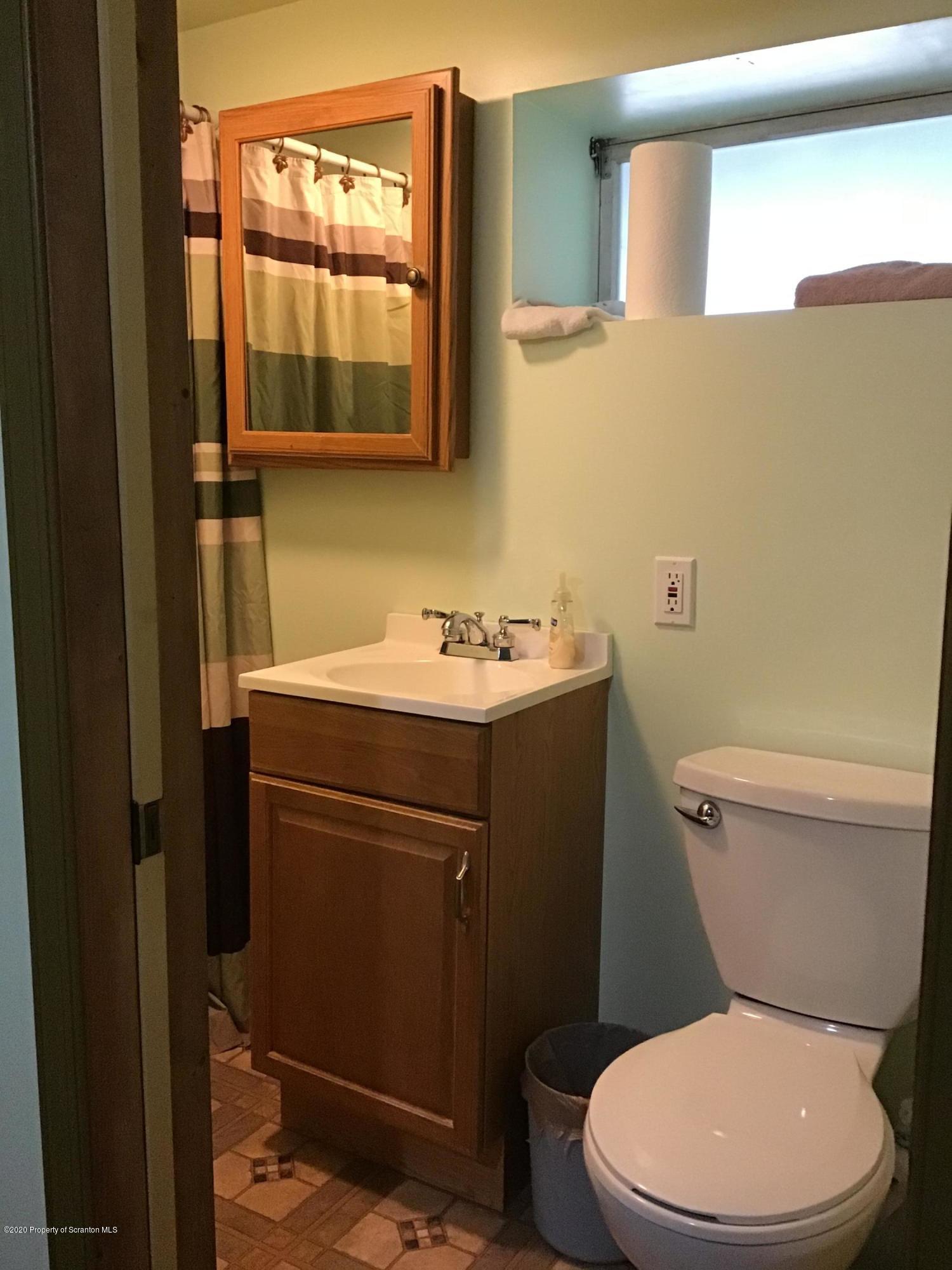 199 Eskra Road Lake Ariel, PA 18436 - Photo 16 of 36 a bathroom with a toilet a sink and mirror