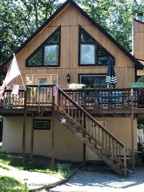 199 Eskra Road Lake Ariel, PA 18436 - Photo 28 of 36 a balcony with wooden floor outdoor seating and oven in the background