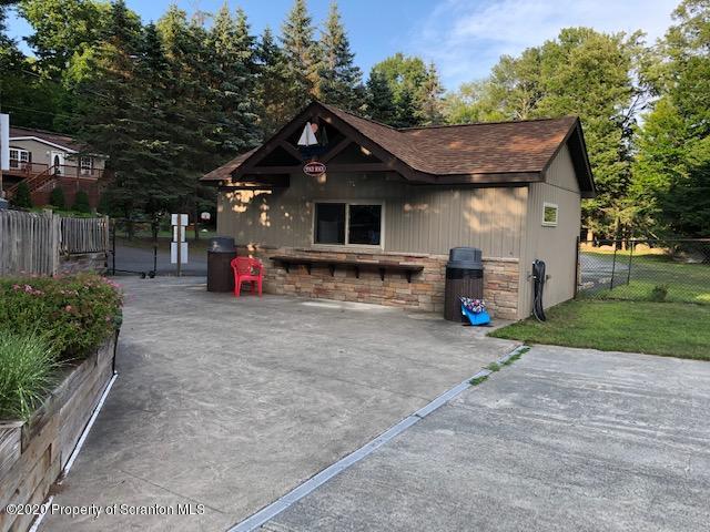 199 Eskra Road Lake Ariel, PA 18436 - Photo 30 of 36 a front view of a house with a yard and garage