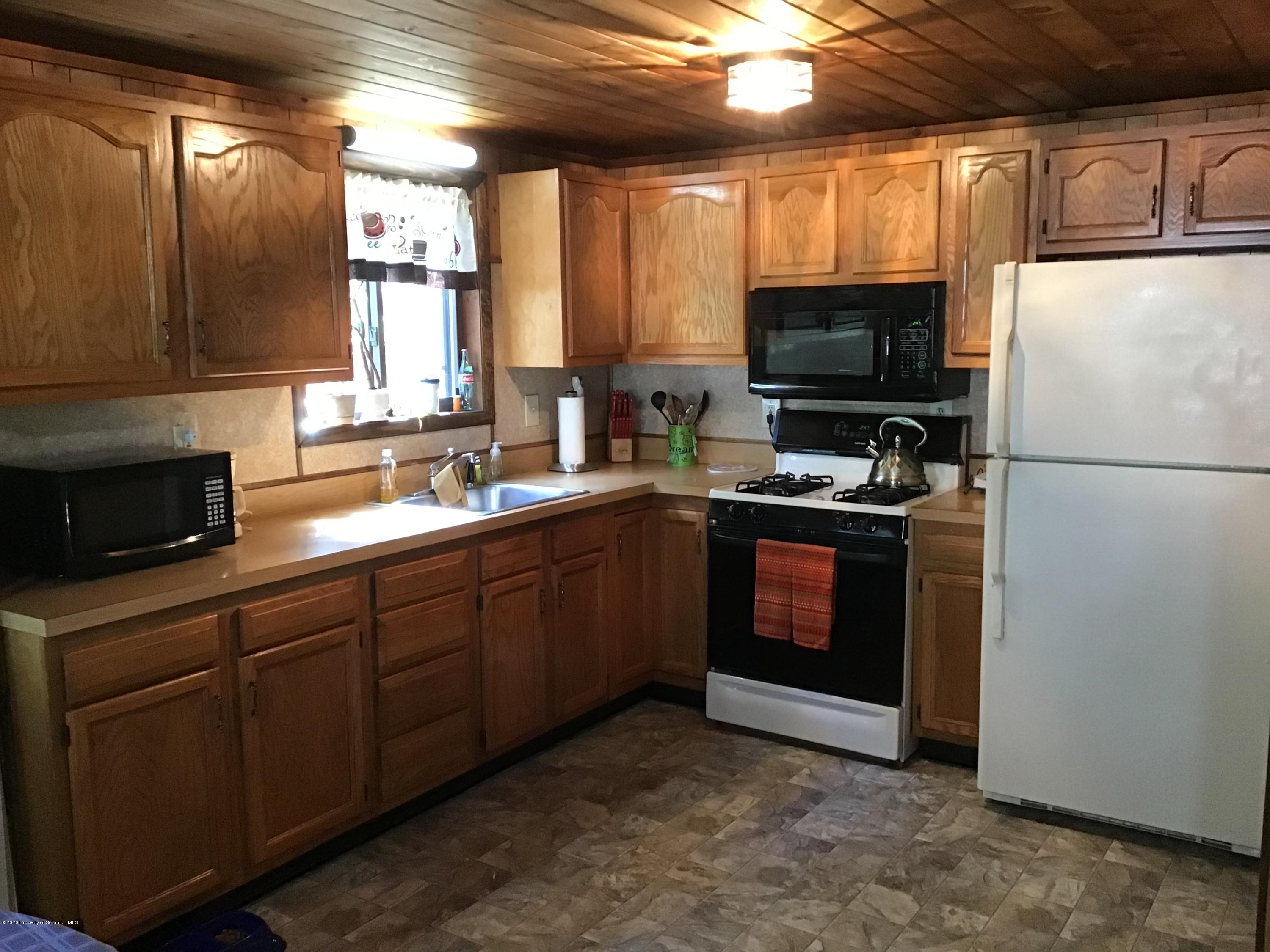 199 Eskra Road Lake Ariel, PA 18436 - Photo 3 of 36 a kitchen with a refrigerator stove and microwave