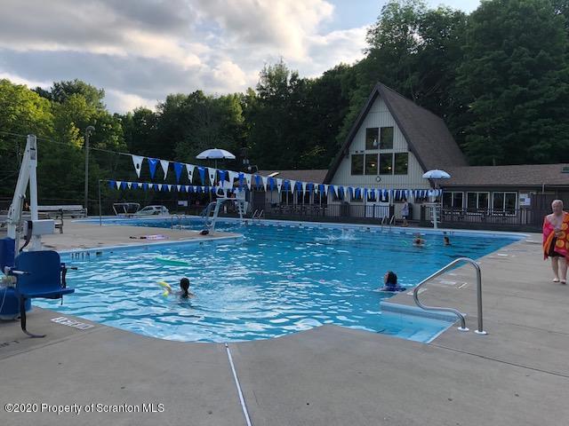 199 Eskra Road Lake Ariel, PA 18436 - Photo 31 of 36 a view of lawn chairs and dinning table under an umbrella