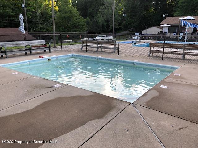 199 Eskra Road Lake Ariel, PA 18436 - Photo 32 of 36 a swimming pool with outdoor seating