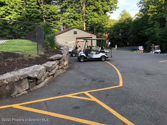 199 Eskra Road Lake Ariel, PA 18436 - Photo 33 of 36 a view of a backyard with table and chairs under an umbrella