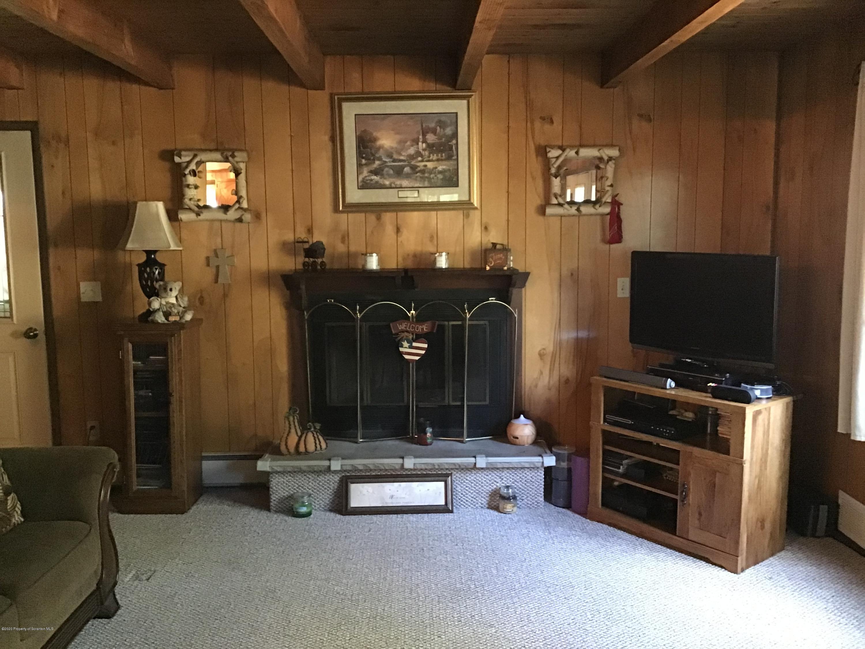 199 Eskra Road Lake Ariel, PA 18436 - Photo 4 of 36 a living room with furniture and a flat screen tv