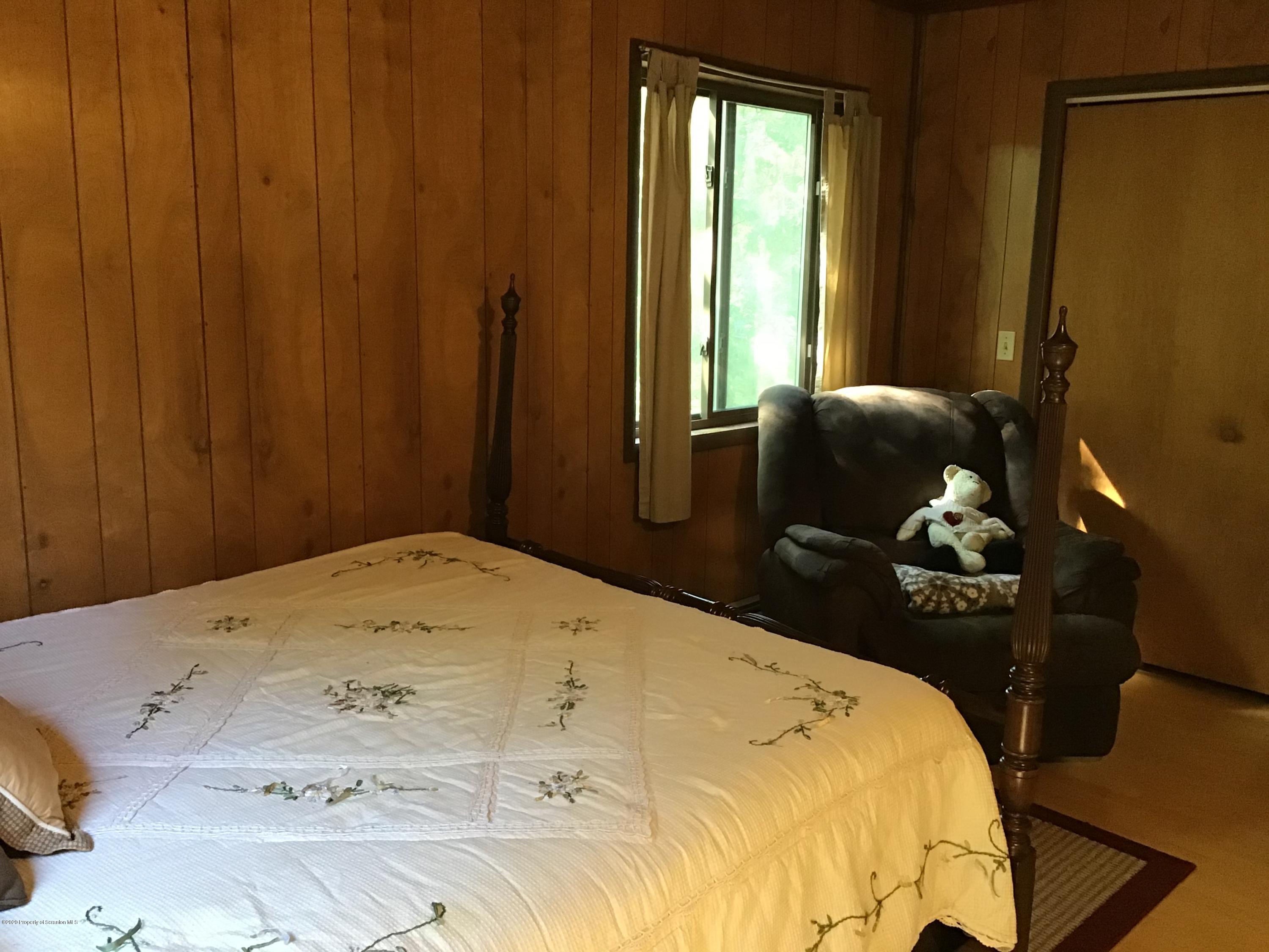 199 Eskra Road Lake Ariel, PA 18436 - Photo 9 of 36 a bedroom with a bed dresser and a window