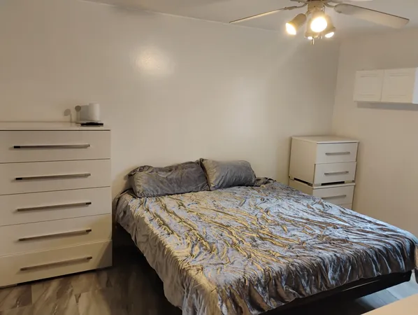 a bed sitting in a bedroom next to a window