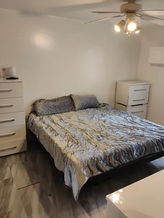 a bedroom with a bed and dresser