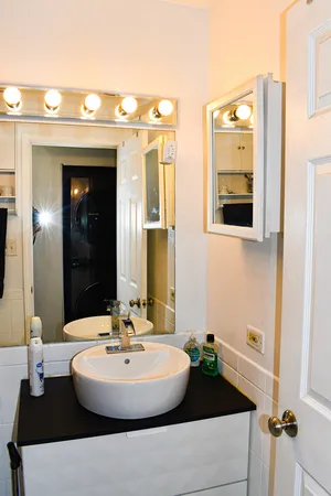 a bathroom with a toilet sink and mirror