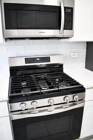 a stove top oven sitting inside of a kitchen