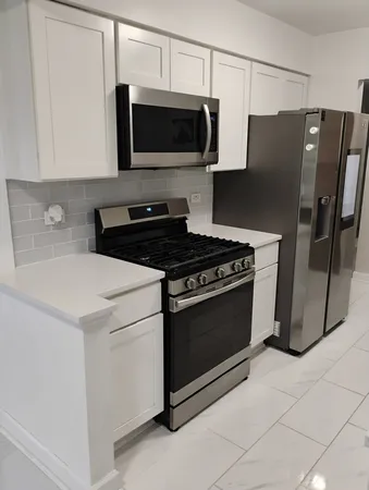 a kitchen with stainless steel appliances a stove a microwave and a refrigerator