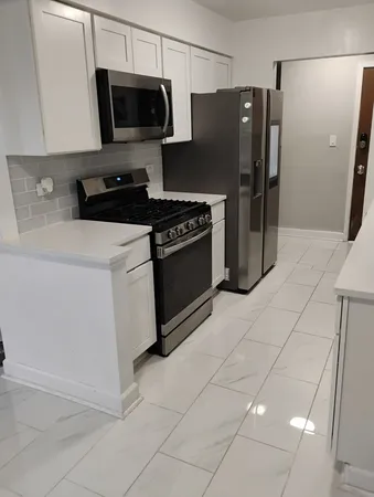a kitchen with stainless steel appliances a refrigerator a stove a microwave and cabinets