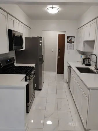 a kitchen with a sink a stove and refrigerator
