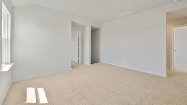 a view of an empty room and a window