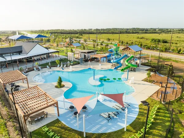 swimming pool view with a lounge chair
