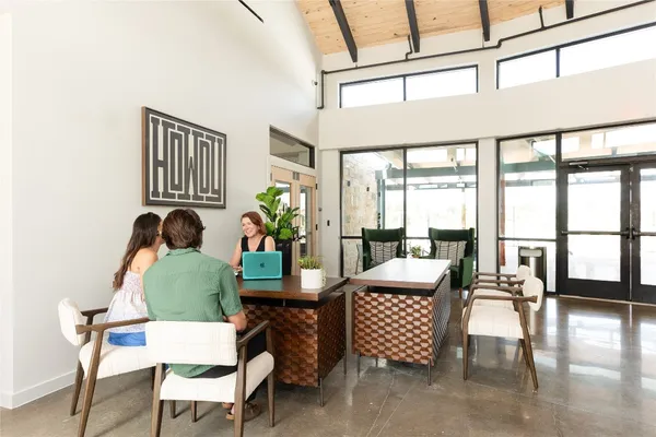 a living room with furniture and floor to ceiling windows