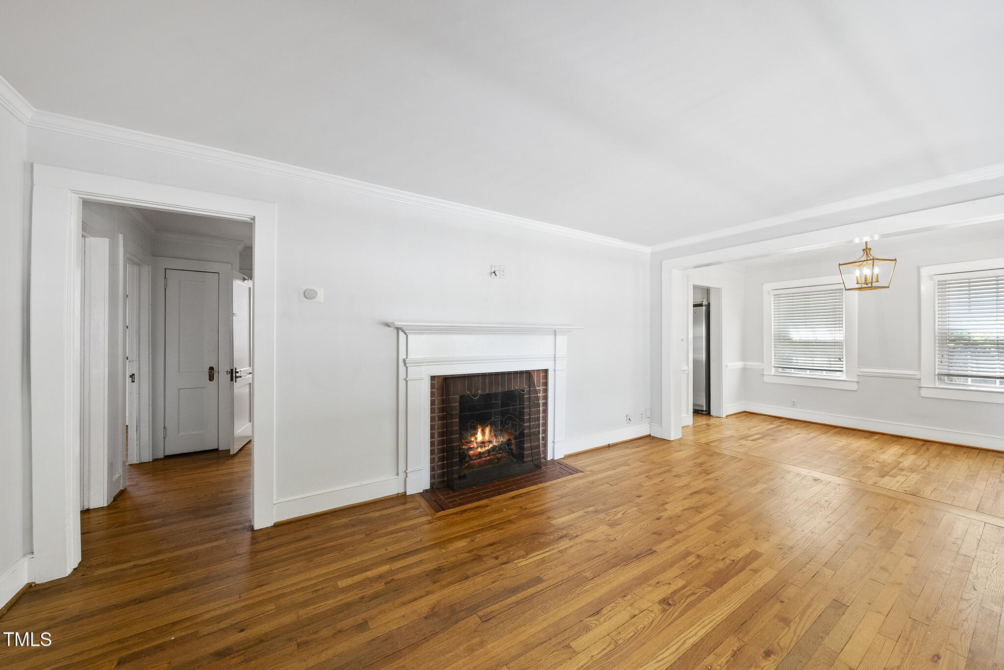 1812 Hilton Street Raleigh, NC 27608 - Photo 5 of 31 a view of empty room with wooden floor and fireplace