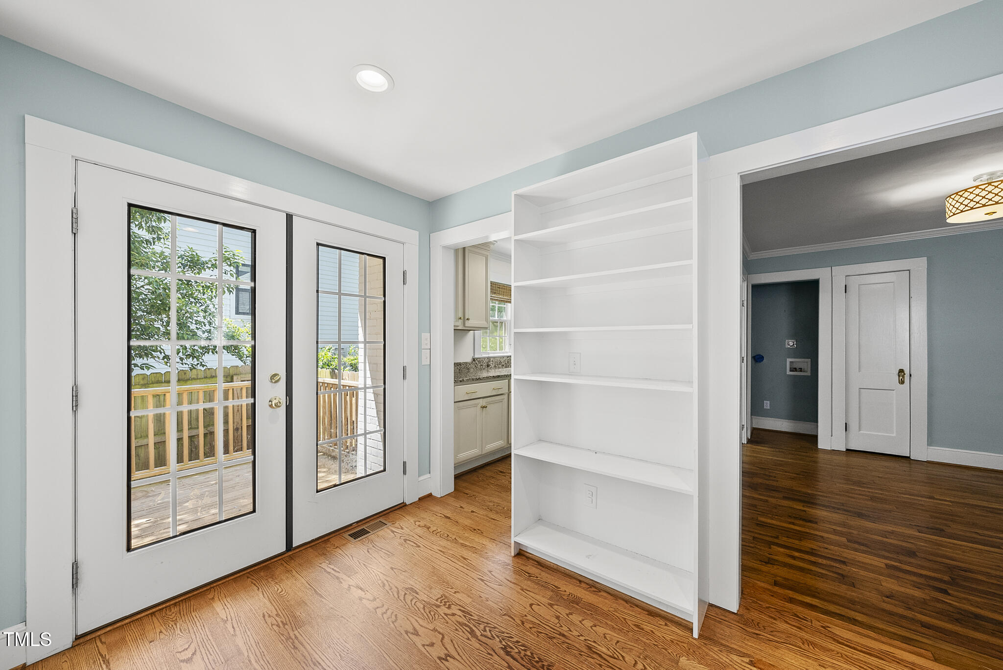 1812 Hilton Street Raleigh, NC 27608 - Photo 10 of 31 a view of an empty room with wooden floor and a window