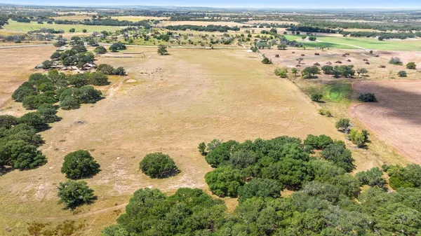 an aerial view of ocean beach and residential houses with outdoor space