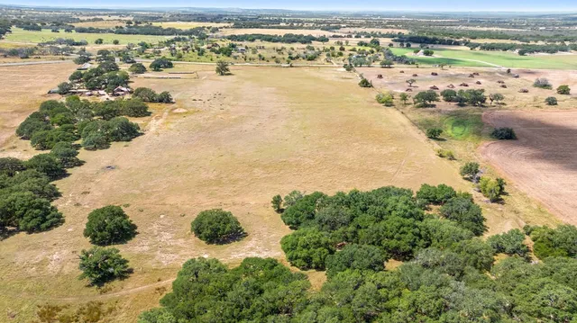 an aerial view of ocean beach and residential houses with outdoor space