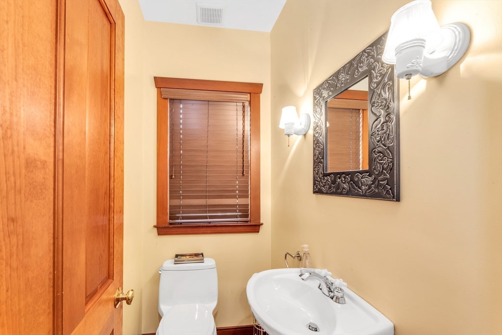 53 B Burroughs Street Boston, MA 02130 - Photo 12 of 41 a bathroom with a sink a mirror and a window