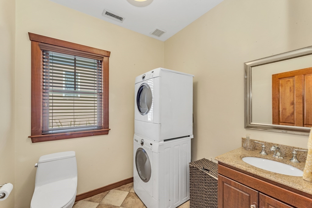 53 B Burroughs Street Boston, MA 02130 - Photo 15 of 41 a bathroom with a sink a toilet and a mirror