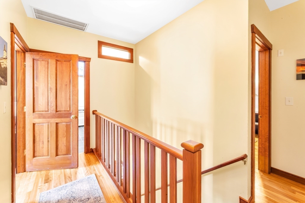 53 B Burroughs Street Boston, MA 02130 - Photo 23 of 41 a view of a hallway with wooden floor and staircase