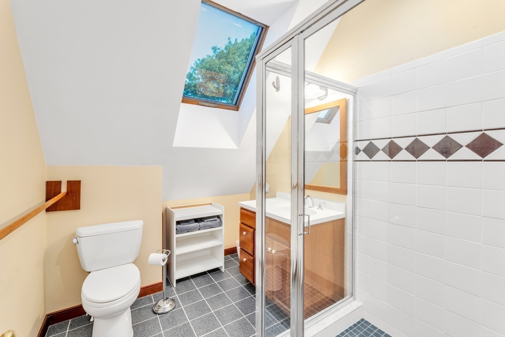 53 B Burroughs Street Boston, MA 02130 - Photo 24 of 41 a bathroom with a toilet sink and a mirror