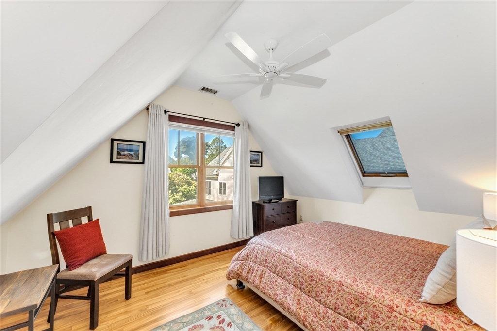 53 B Burroughs Street Boston, MA 02130 - Photo 26 of 41 a bedroom with a bed and wooden floor