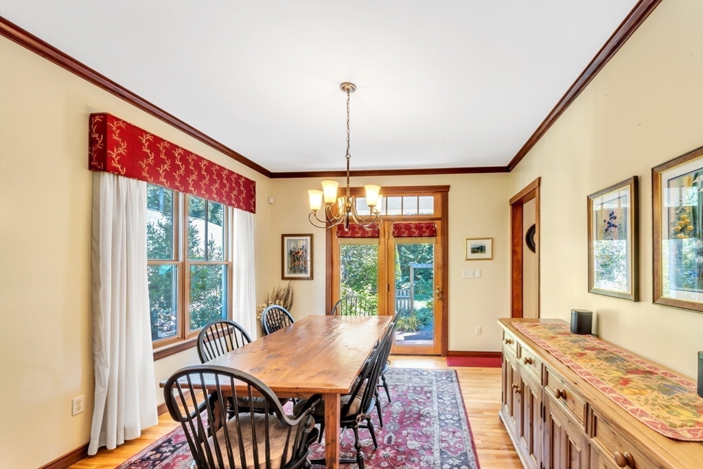 53 B Burroughs Street Boston, MA 02130 - Photo 7 of 41 a dining room with furniture a chandelier and wooden floor