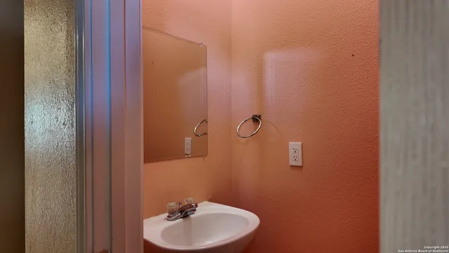 a bathroom with a sink a mirror and vanity