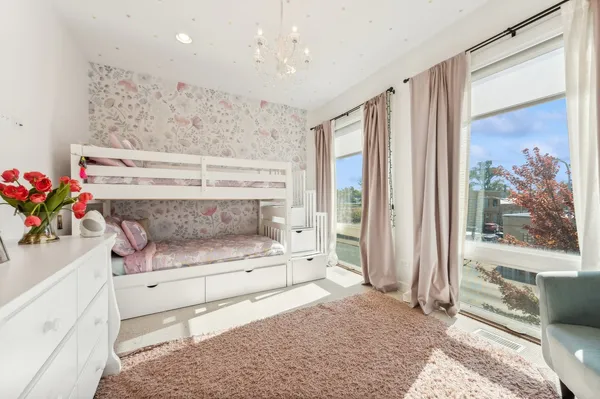 a bedroom with furniture and a window